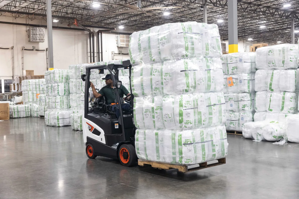 Forklift handling palletized goods in a distribution center